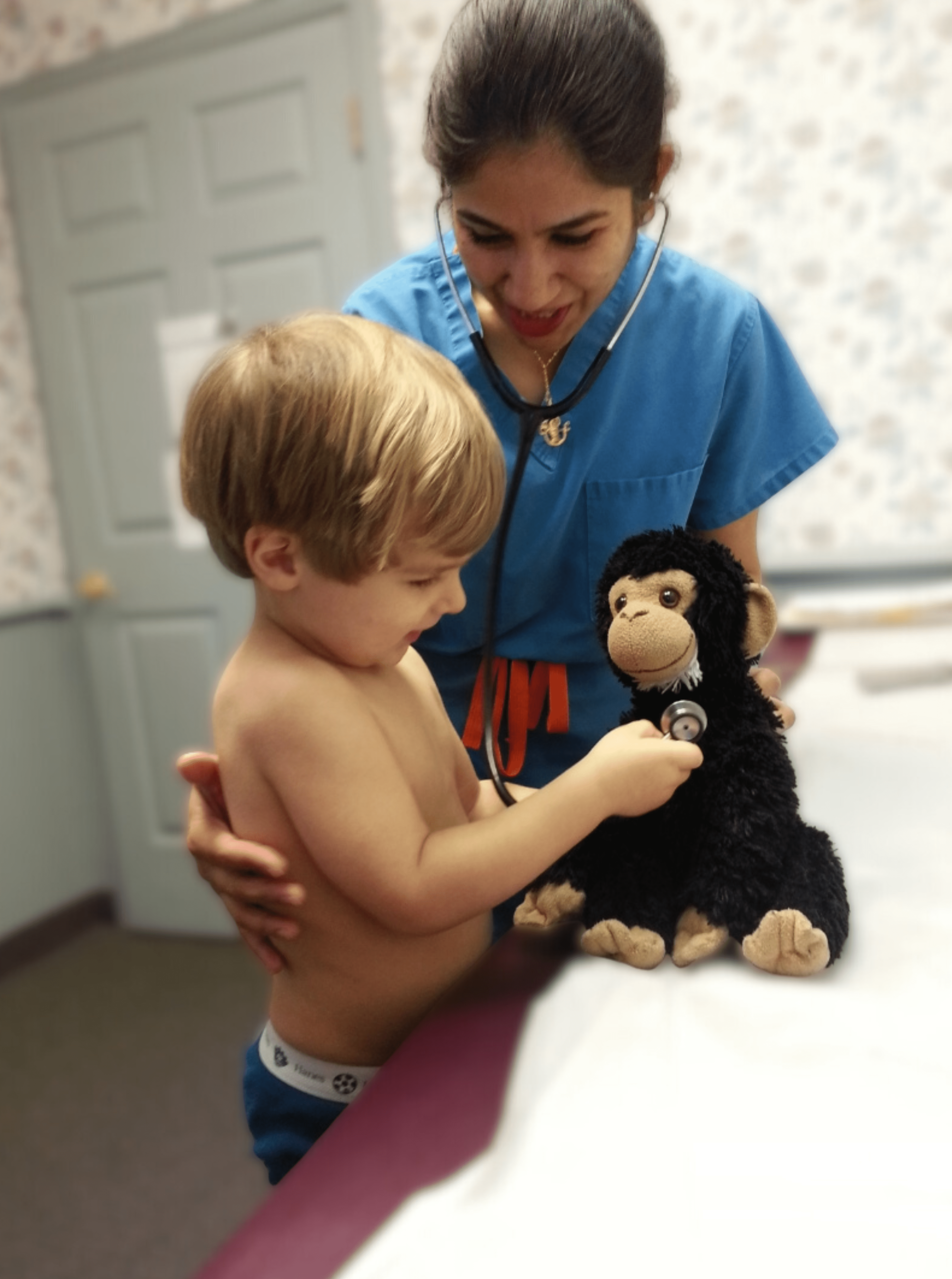 Doctor With a Stethoscope Listening to a Child's Toy
