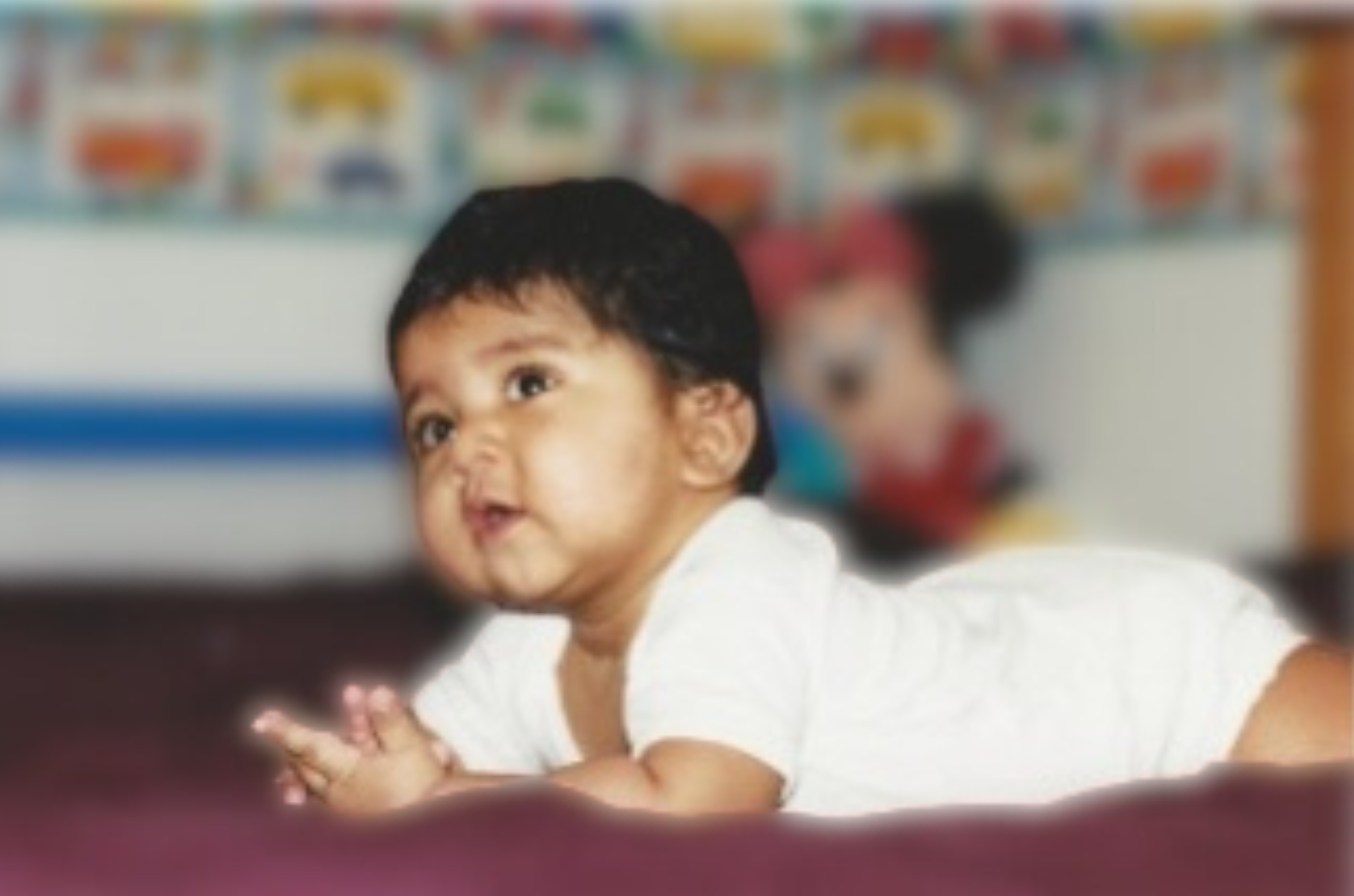 A Baby Lying on the Floor